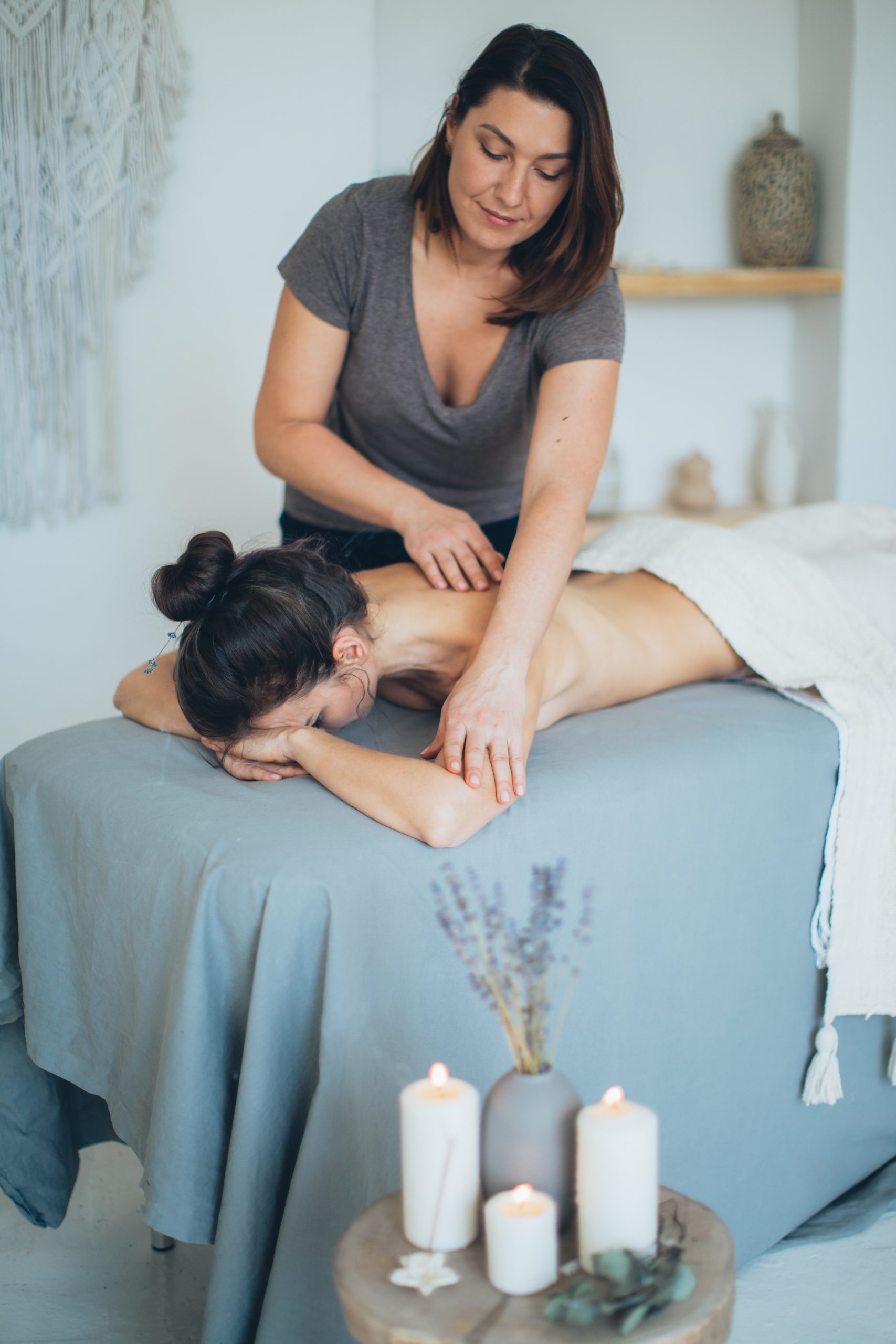 woman-lying-on-bed-while-having-a-massage-3865792-1